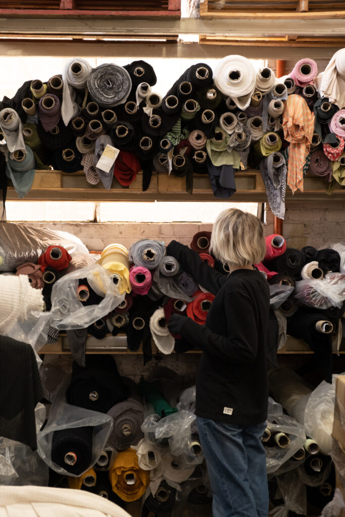 A.BCH Founder Courtney Hom, browsing surplus fabric stocks in Melbourne